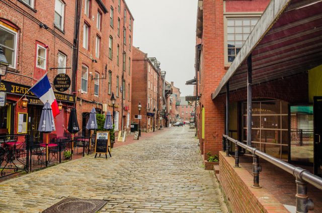 a-cobbled-street-lined-with-shops-and-pubs-in-the-old-port-district-19th