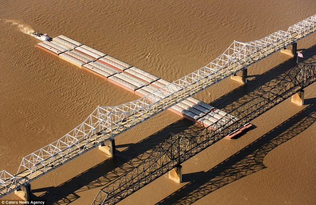 these-are-the-vicksburg-bridges-located-on-the-mississippi-river-show-a-barge-making-its-way-underneath-them